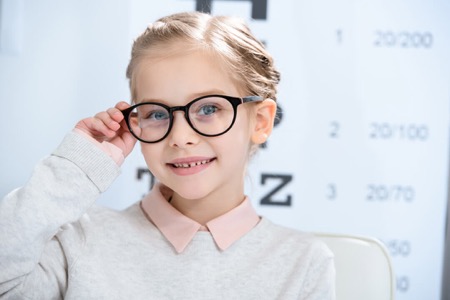 Child wearing glasses in a doctor's office