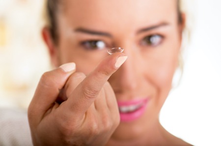 contact lens on woman's finger