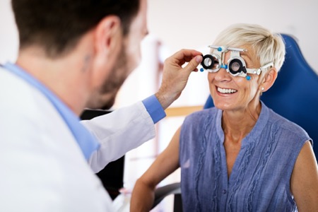 Older woman getting preventative vision check to detect diabetic eye disease