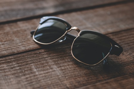 Ray-Ban brow-line wayfarer sunglasses on a wooden table