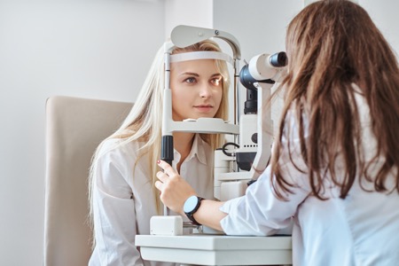 woman getting eye exam for contact lenses